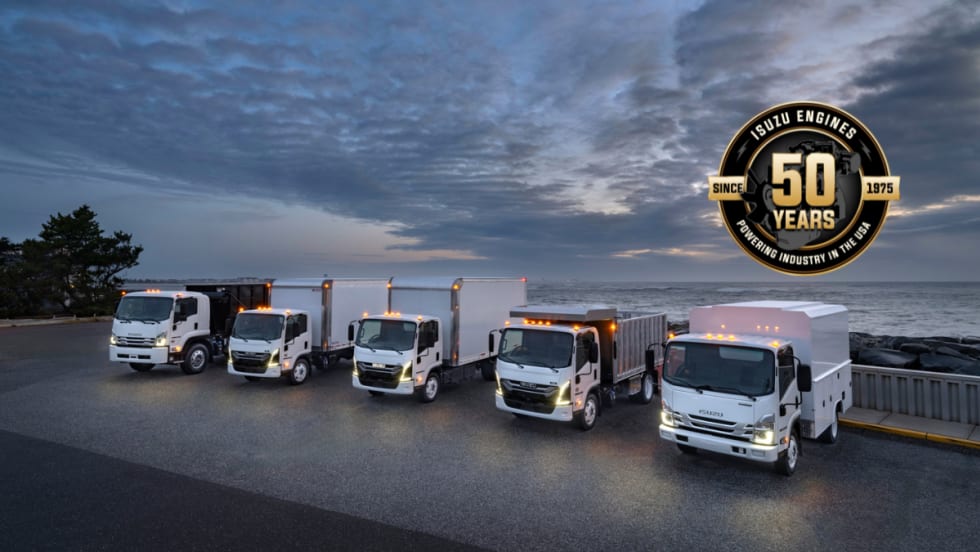 Line up of Isuzu trucks outside.