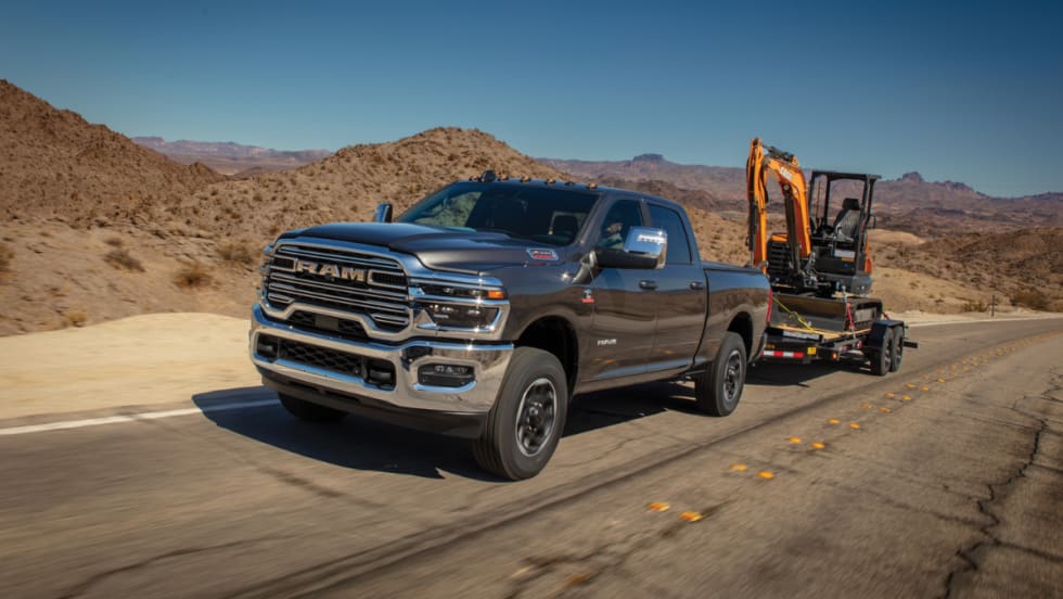A Ram truck hauling construction equipment.
