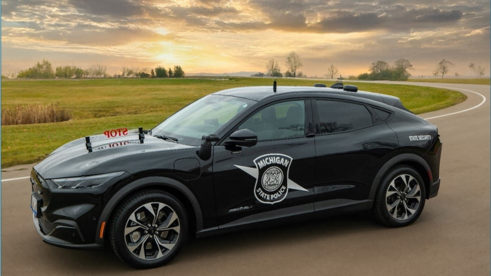 A black Mustang Mach-E is upfitted with Michigan State Police's longtime 'Stop State Police' sign on the hood.
