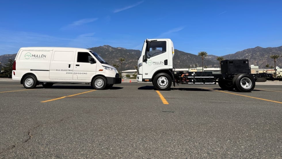 Two Mullen vehicles face each other in a parking lot. 