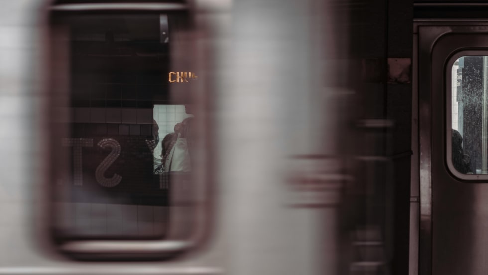A blurry image of a subway vehicle passing by.