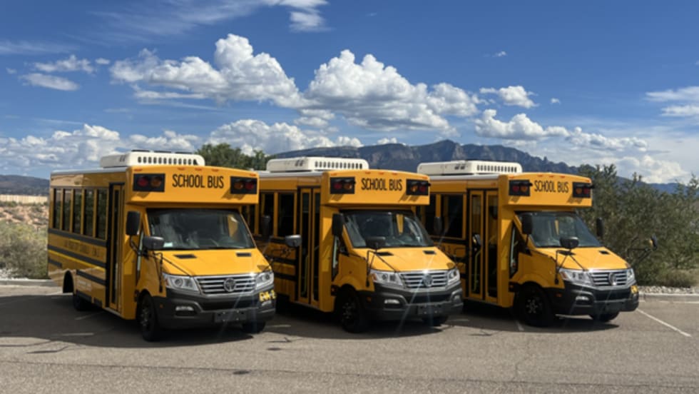 Three GreenPower Buses lined up outside in new mexico against a blue sky