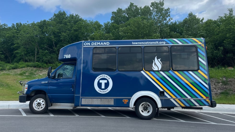 A blue Lawrence Transit on-demand service bus. 