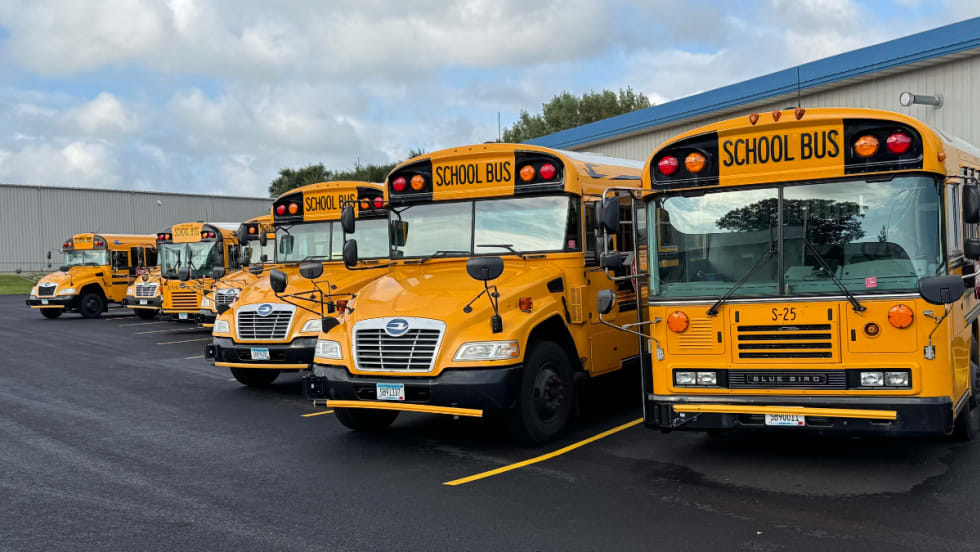 Spanier Bus Service buses lined up in parking spots.