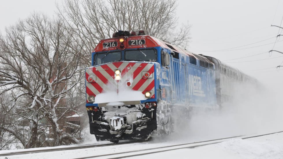 A Metra train operating in the snow.