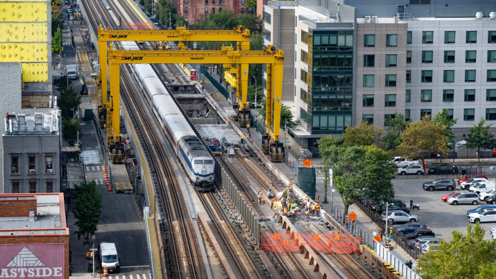 Aerial view of a Metro-North train passing through the gantry system.