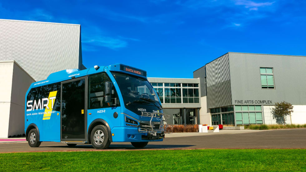 A blue SMRT Microtransit bus.