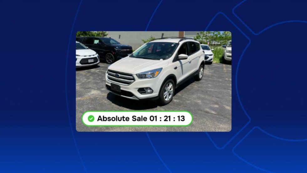Wholesale vehicle pictured in parking lot available for real-time digital online sale.