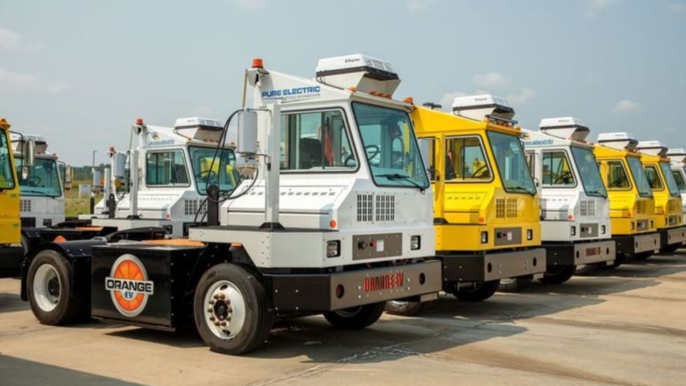 Orange EV terminal tractors. 