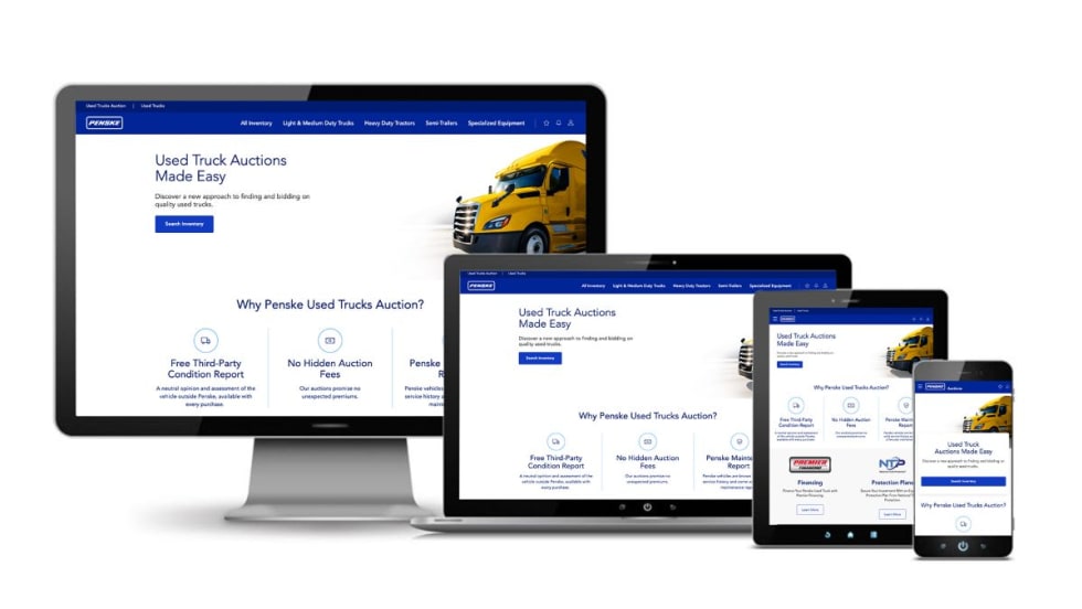 Computer screens with Penske online auction platform displayed.