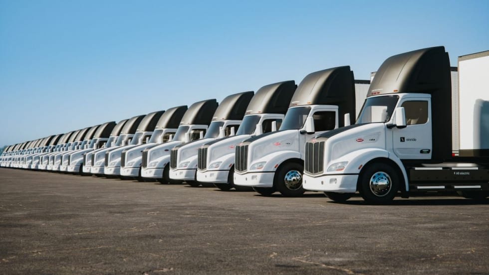 A row of new Peterbilt Model 579EV electric trucks.