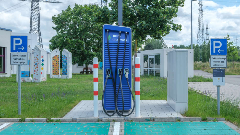 public electric vehicle charging station with one charger and two parking spots