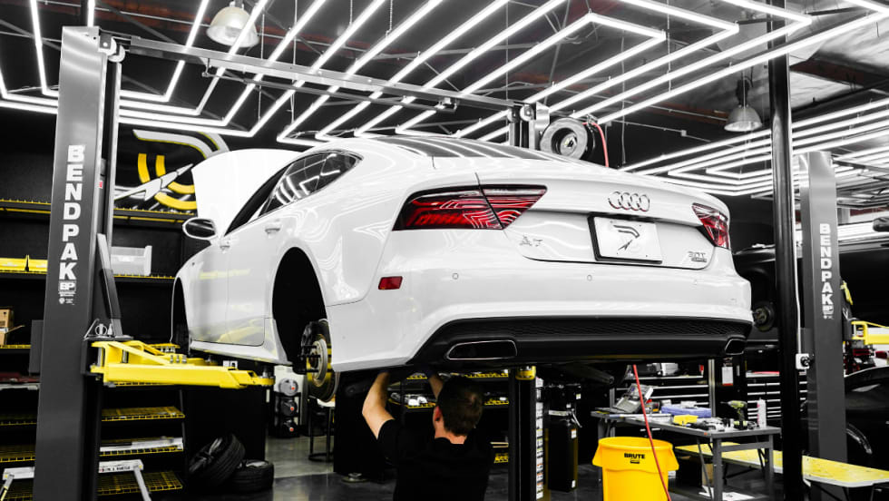white Audi car in a service bay