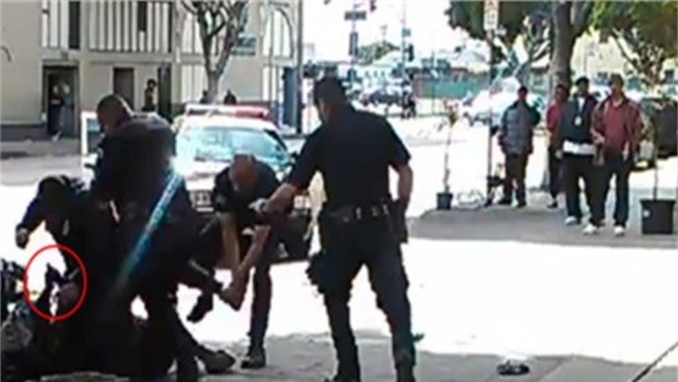 LAPD officers shot and killed a convicted bank robber Sunday after he reportedly tried to grab one of the the officers' guns.