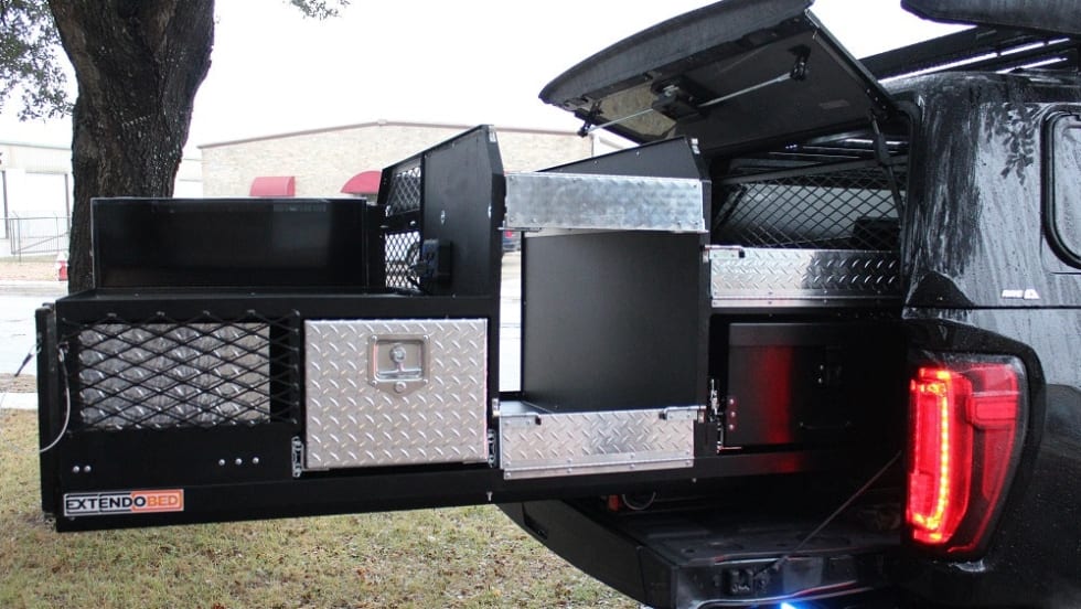 Truck bed storage system with open compartments and diamond plate panels