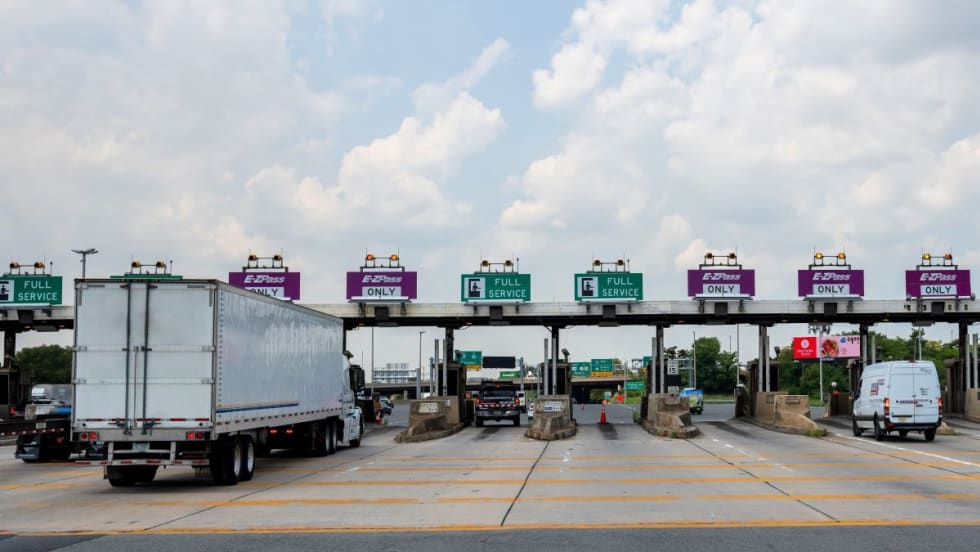Trucks at a highway tolling station.