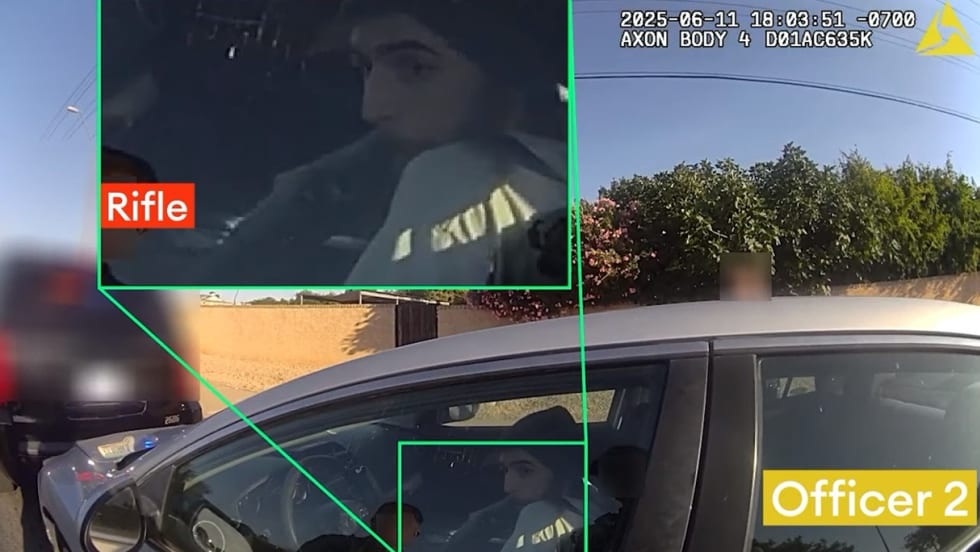 Police body camera view of vehicle interior with person holding rifle