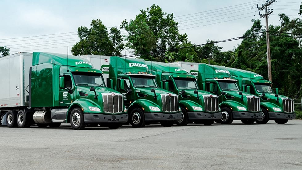 Row of green Cowan tractor-trailers