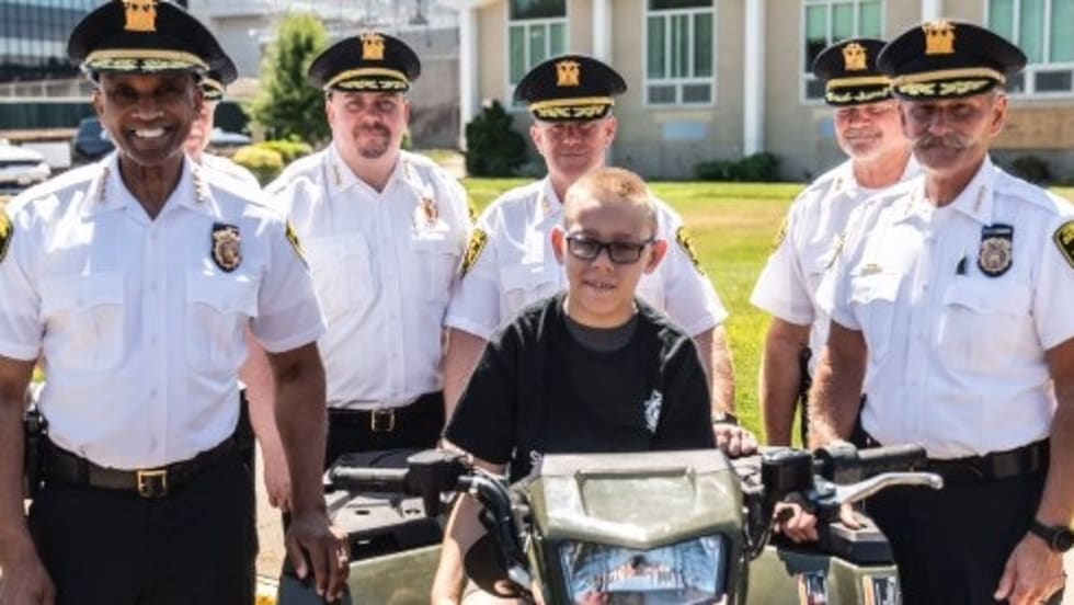 Police officers standing with a civilian near police bicycles outdoors