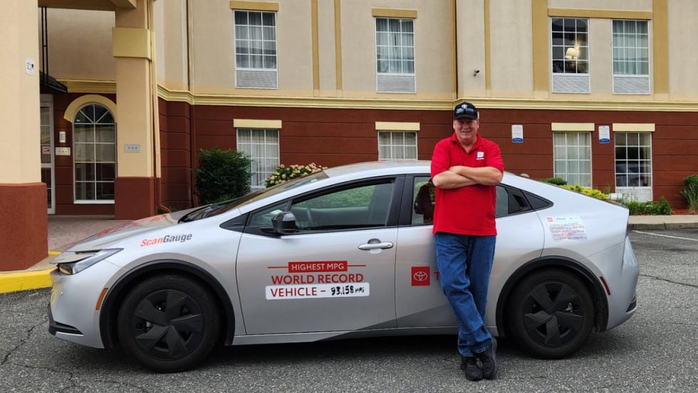 Wayne Gerdes poses in front of the Toyota Prius he drove across the country.