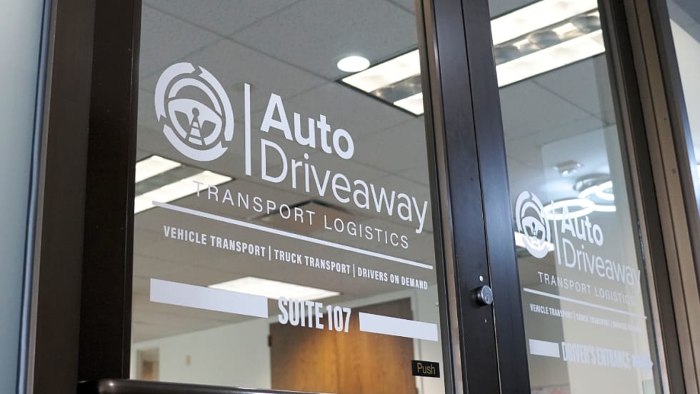 The business front to Auto Driveway with the company logo on the door.