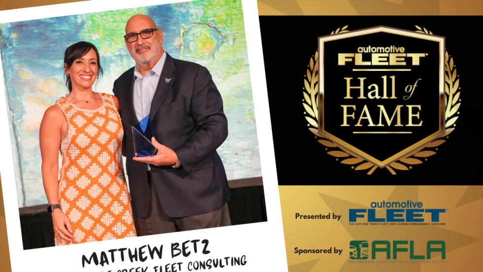 A black and gold graphic with an emblem for "Fleet Hall of Fame" and a polaroid element with a picture of Betz and his daughter.