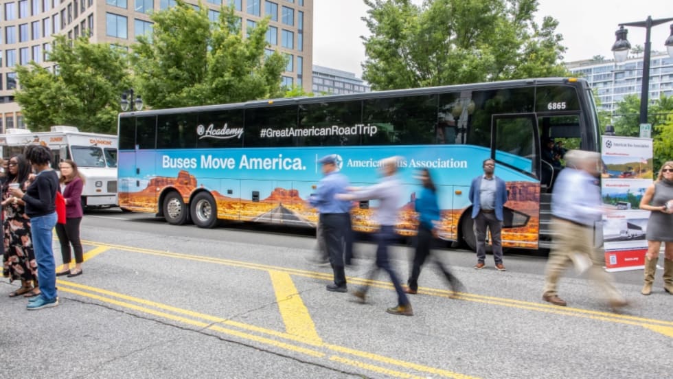 A Great American Road Trip motorcoach bus at an event.