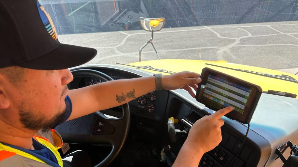 A driver managing his routing tablet