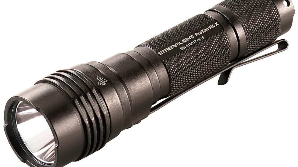 Black tactical LED flashlight with textured grip and bright lens