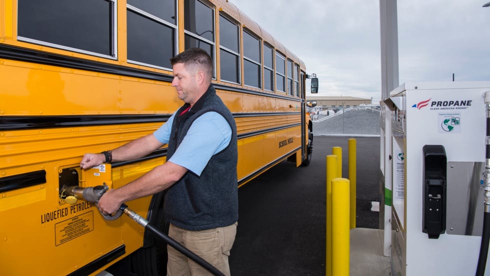 a school bus refuels at a propane station