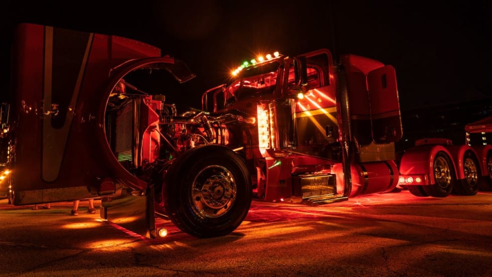 Peterbilt truck lit up at night.