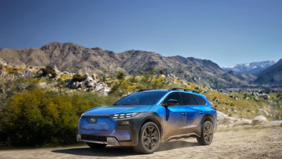 A blue 2026 Subaru Trailseeker sits on a desert landscape. 