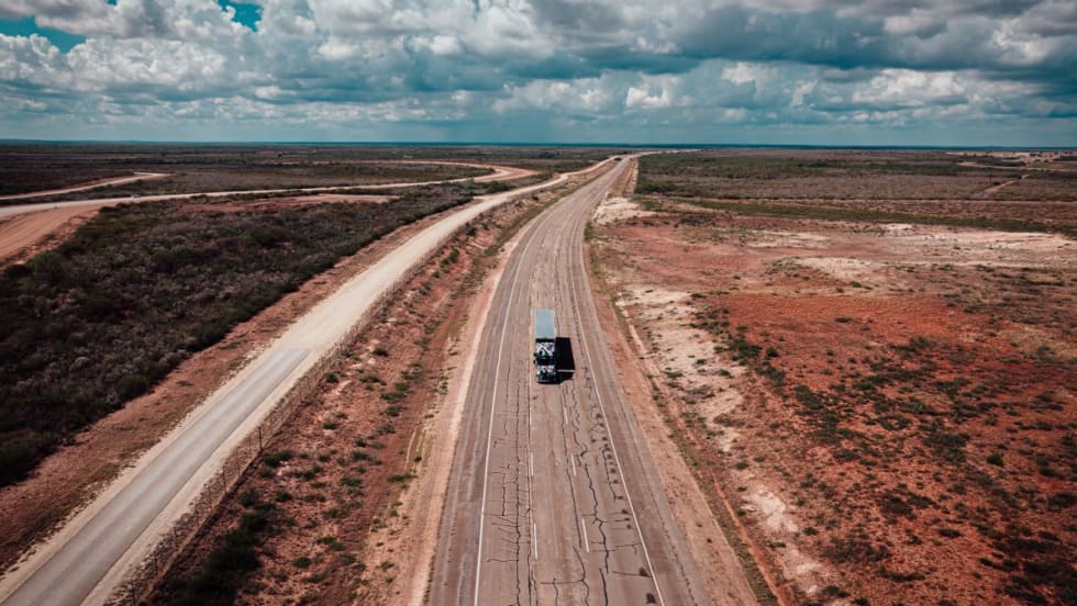 Autonomous truck on a desert highway.
