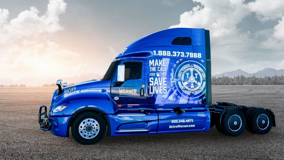 Blue Werner heavy-duty truck tractor with TAT human trafficking prevention wrap