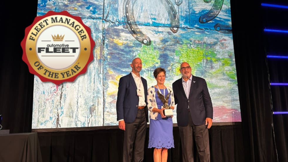 Fleet manager receives award on stage.