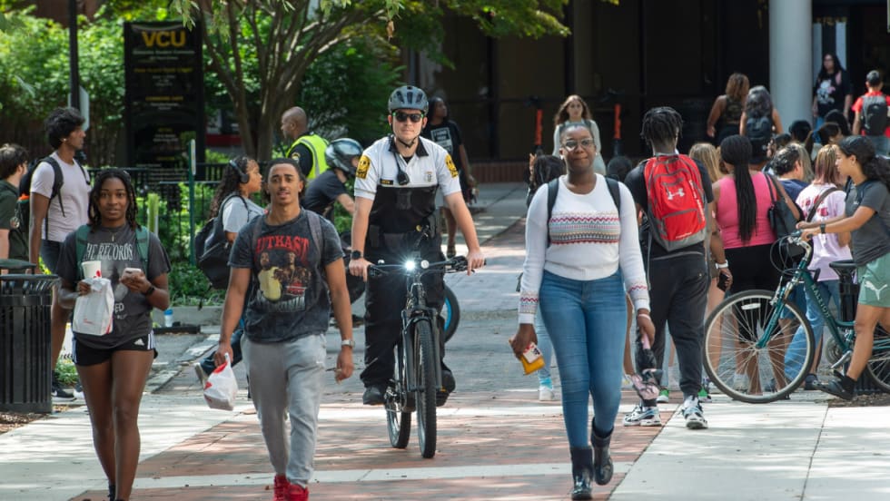 An officer rides an e-bike through the campus of Virginia Commonwealth University.