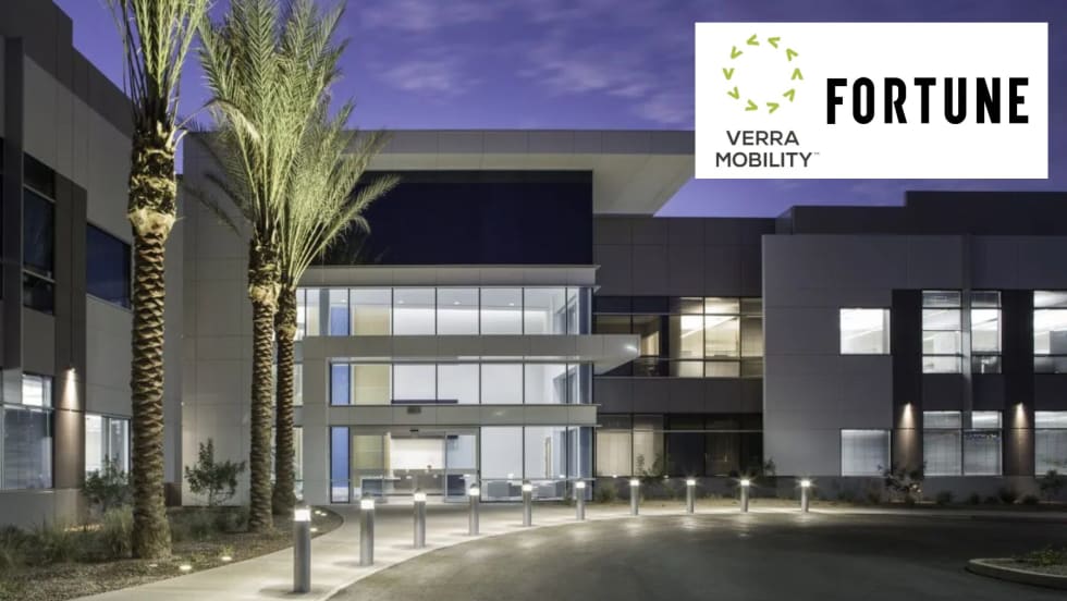 the exterior of an office building with two logos