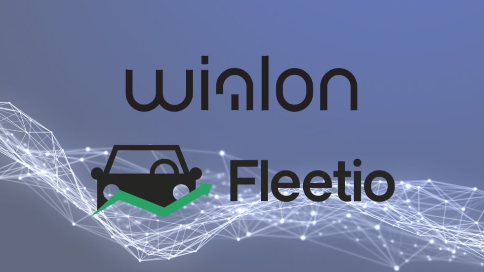 Wialon and Fleetio logos in front of a picture of lines that connect. 