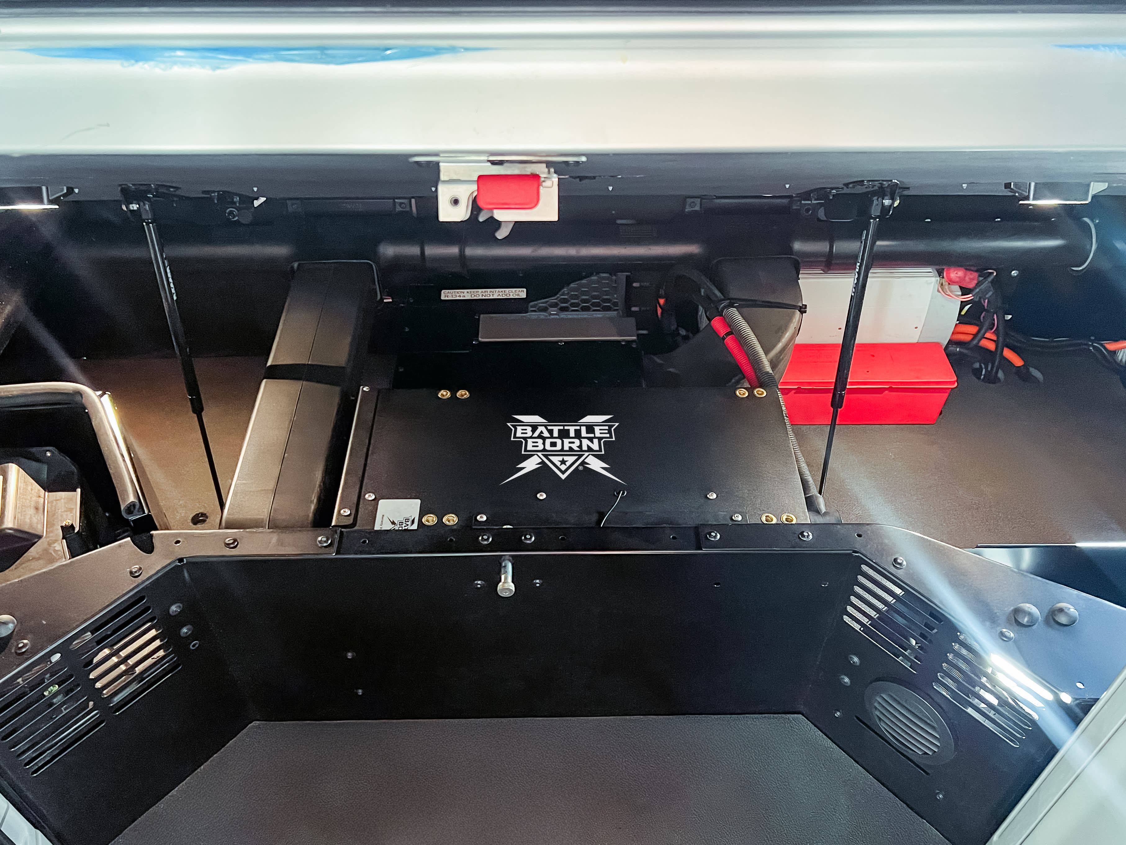 A Battle Born DualFlow Power Pack installed in a sleeper cab of trick. Battle Born logo is facing upward.