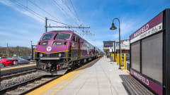 A purple MBTA train at a Mansfield Station platform.