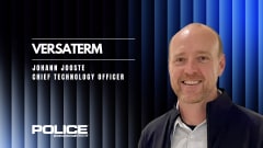 man in business attire against a black and blue corrugated background and headlines for Versaterm and the man's name and title.