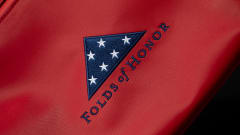 Red fabric background with blue and white Folds of Honor logo.