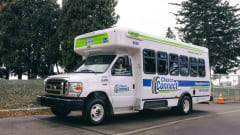 A white Chesco Connect paratransit bus parked outside.