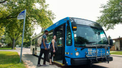 Passenger boarding Saskatoon Transit bus.