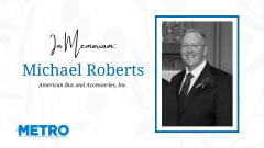 a black and white photo of michael roberts against a white flowery background with text that says "In memoriam Michael Roberts" and the metro logo