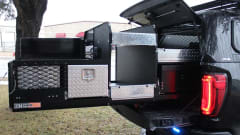 Truck bed storage system with open compartments and diamond plate panels