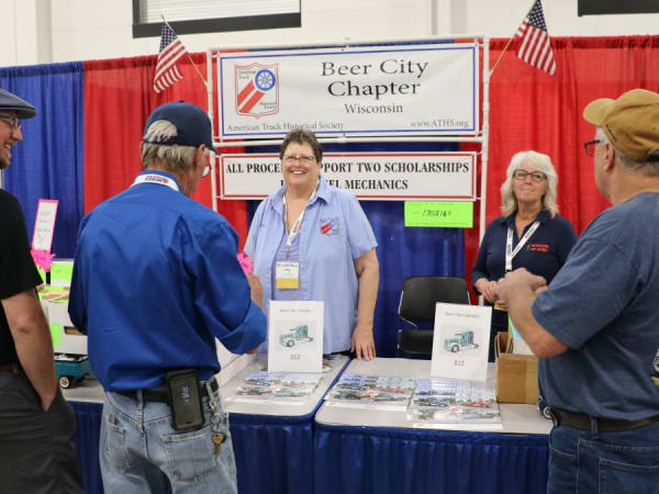 Group of people at a booth for ATHS Beer City chapter