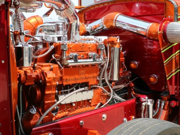 Classic truck with hood open to display engine with chrome accents