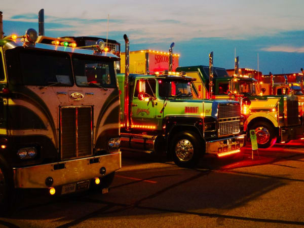 A line of antique trucks at sunset