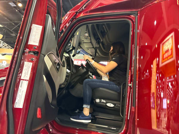 Woman behind wheel of red Peterbilt truck